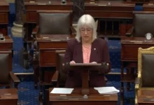 Wildfire smoke rising over forests near the Canada–U.S. border as U.S. Senator Patty Murray responds to criticism of Canada's wildfire response.