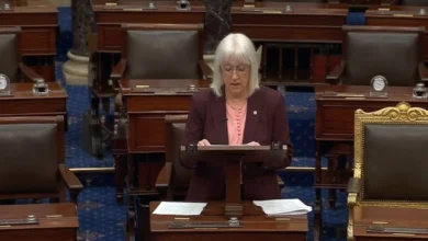 Wildfire smoke rising over forests near the Canada–U.S. border as U.S. Senator Patty Murray responds to criticism of Canada's wildfire response.