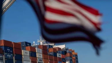 Shipping containers at a U.S. port following the implementation of new import tariffs on goods from nearly 60 countries.