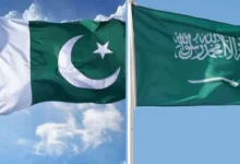 Pakistan and Saudi Arabia flags with U.S. dollar currency and financial charts representing the three-year extension of Pakistan's $5 billion Saudi loan.