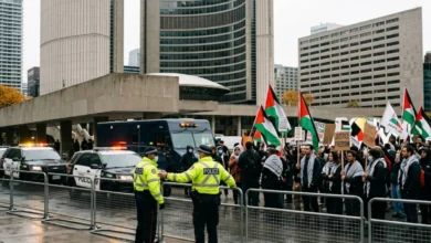 Toronto Police Service headquarters with police vehicles outside, overlaid with a courthouse silhouette and the Toronto skyline. Avoid using Hamas logos or extremist imagery.