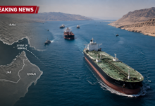 Large oil tankers sailing through the Strait of Hormuz with naval patrol vessels as Oman proposes a joint regional maritime security framework.