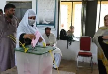 Voters arrive at polling stations during the third phase of Azad Kashmir elections