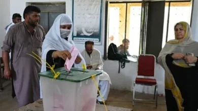 Voters arrive at polling stations during the third phase of Azad Kashmir elections