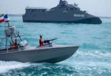 Strait of Hormuz with commercial ships and Iranian maritime forces