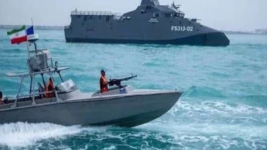 Strait of Hormuz with commercial ships and Iranian maritime forces