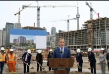 Modern apartment buildings under construction in Toronto representing Canada's $2.7 billion housing initiative to build 5,600 new rental homes.