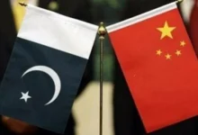 Pakistan and China national flags representing discussions on a $1.3 billion loan refinancing agreement to support Pakistan's foreign exchange reserves.