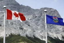 Alberta and Canadian flags representing the debate over Alberta’s future in Canada ahead of the 2026 referendum