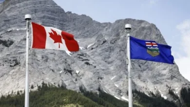 Alberta and Canadian flags representing the debate over Alberta’s future in Canada ahead of the 2026 referendum
