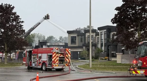 Residential homes damaged in an alleged arson incident in Ajax, Ontario, that led to 11 charges against a 24-year-old man.