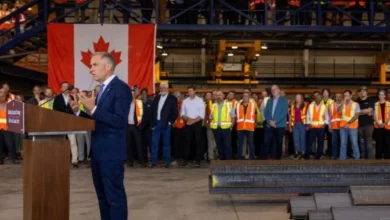 Canadian Prime Minister Mark Carney speaking at an event amid economic challenges involving US tariffs, federal deficits and economic growth.