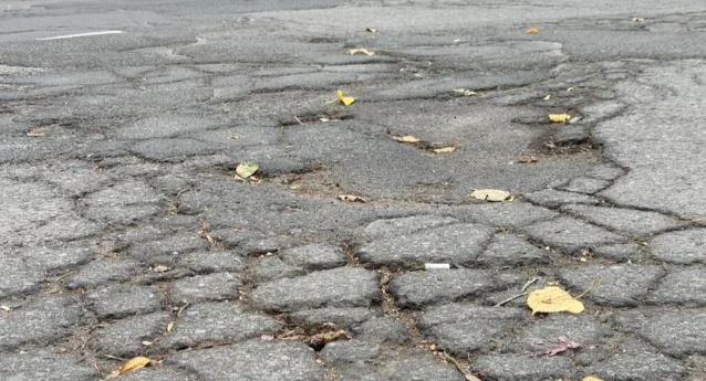 A large pothole on a Montreal street highlights deteriorating road conditions and ongoing maintenance challenges ahead of winter.